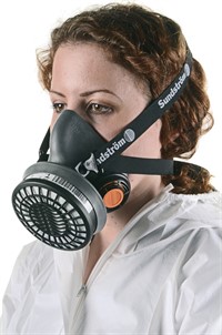 A woman wearing a PPE mask